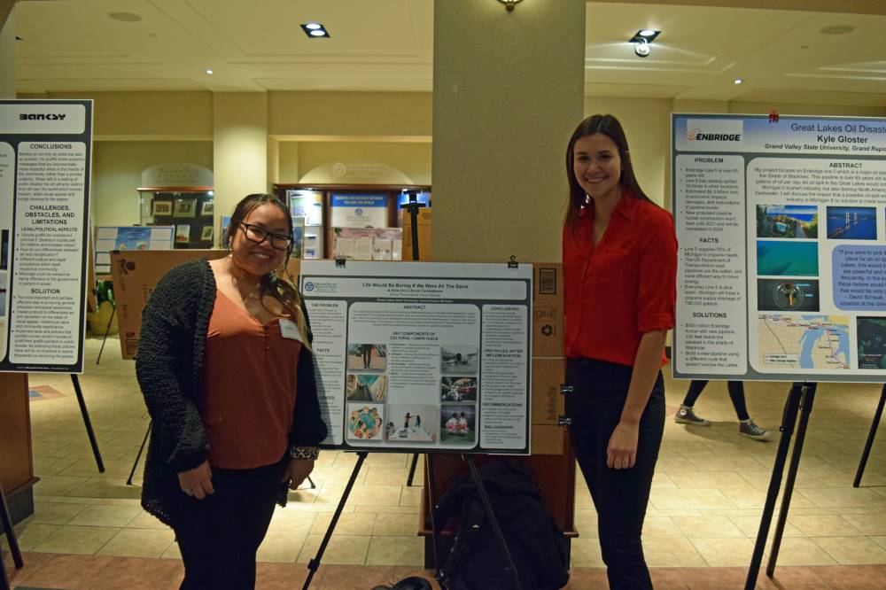 Annie Phommala and Grace Kenney with their poster